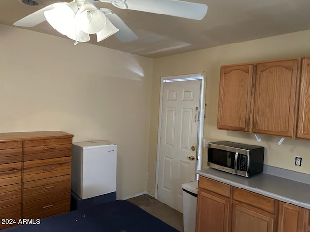 kitchen featuring ceiling fan and white refrigerator