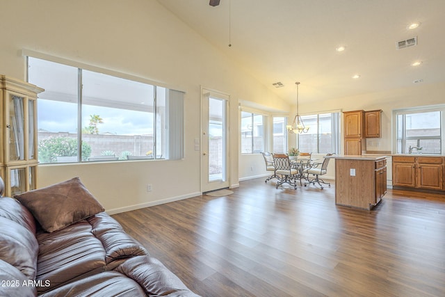 living room featuring visible vents, a healthy amount of sunlight, and dark wood finished floors