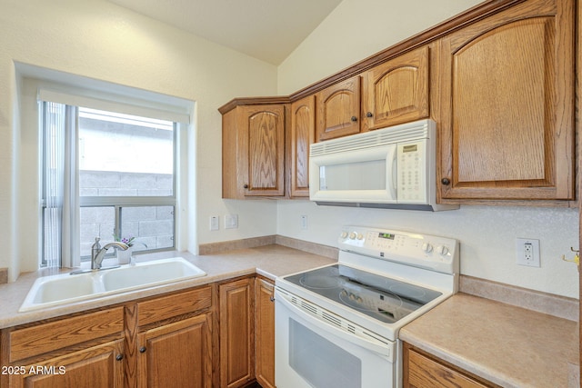 kitchen featuring brown cabinets, a sink, white appliances, light countertops, and lofted ceiling