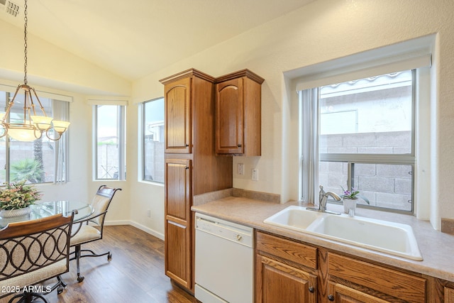 kitchen with vaulted ceiling, a sink, plenty of natural light, and white dishwasher