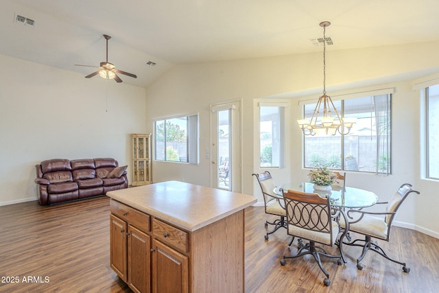 kitchen with dark wood-style floors, visible vents, and lofted ceiling