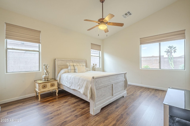 bedroom featuring visible vents, ceiling fan, baseboards, vaulted ceiling, and wood finished floors