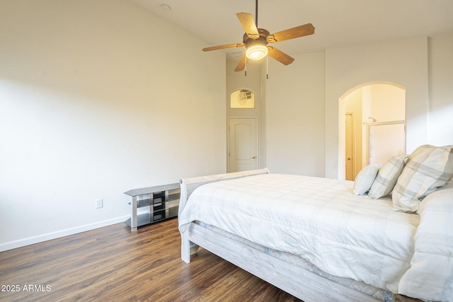 bedroom featuring a ceiling fan, baseboards, high vaulted ceiling, arched walkways, and dark wood-type flooring