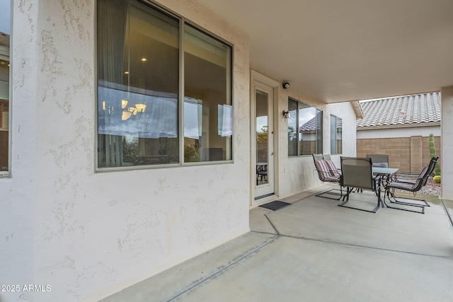 view of patio / terrace with outdoor dining space and fence