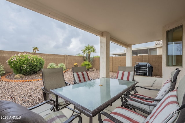 view of patio with outdoor dining space and a fenced backyard