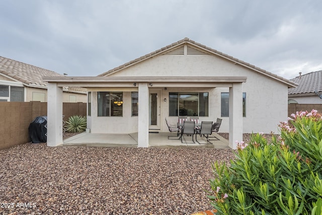 back of house with a patio area, stucco siding, and fence