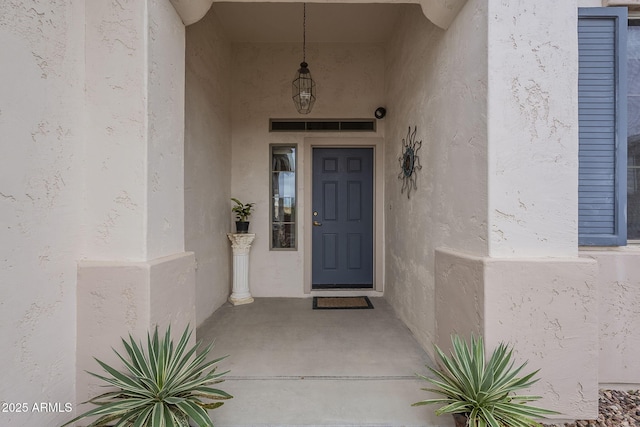 view of exterior entry featuring stucco siding