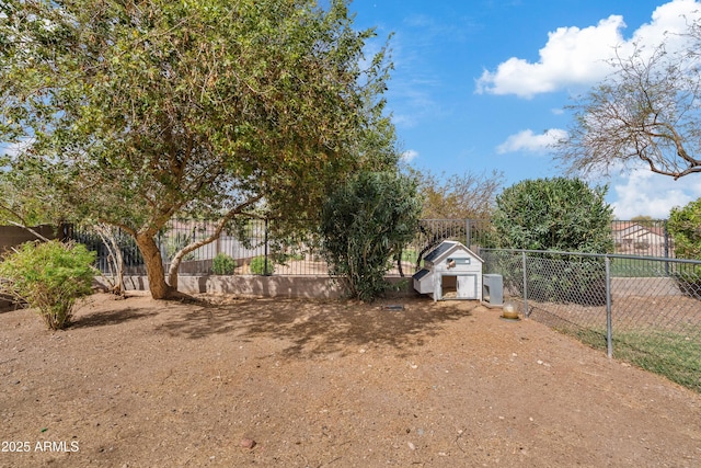 view of yard with an outbuilding, exterior structure, and fence