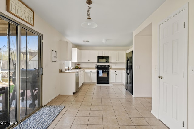 kitchen with light tile patterned floors, black appliances, a sink, and white cabinetry