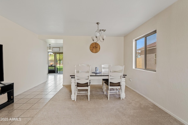 carpeted dining room with tile patterned flooring and visible vents