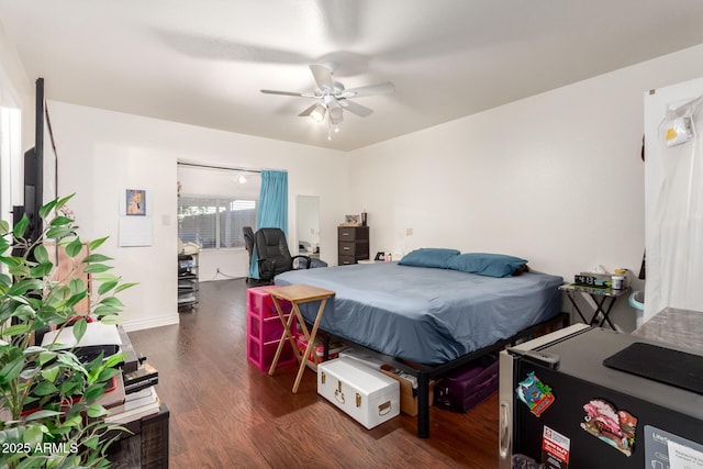 bedroom featuring ceiling fan and dark hardwood / wood-style floors