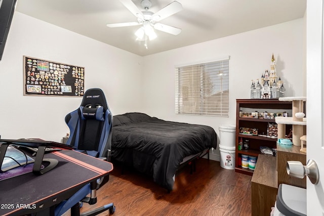 bedroom with dark hardwood / wood-style flooring and ceiling fan