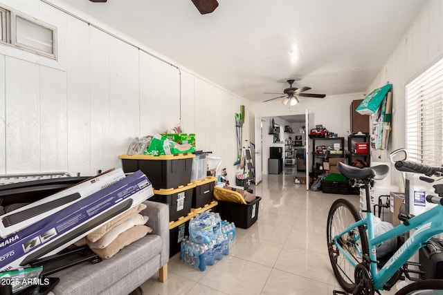 interior space featuring light tile patterned flooring and ceiling fan