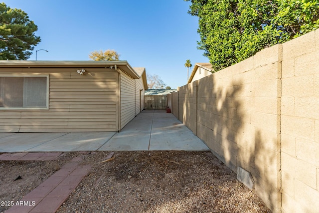 view of side of property with a patio area