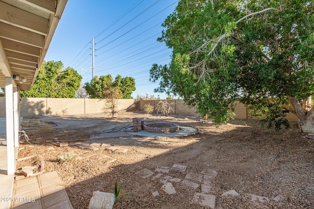 view of yard with a fire pit