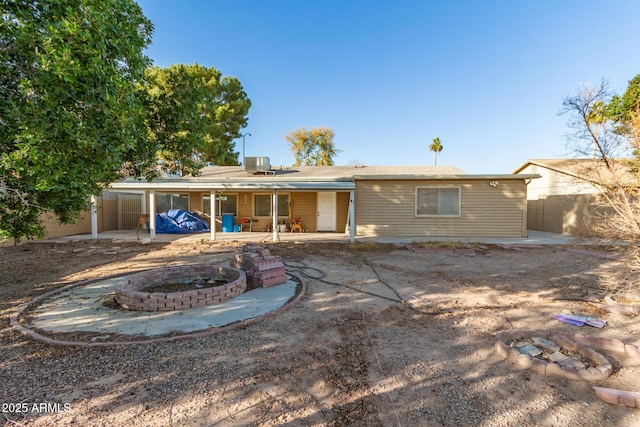 rear view of house with an outdoor fire pit and a patio area