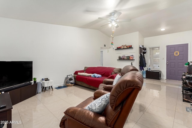 living room with ceiling fan, vaulted ceiling, and light tile patterned floors