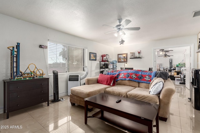 tiled living room featuring ceiling fan and a textured ceiling