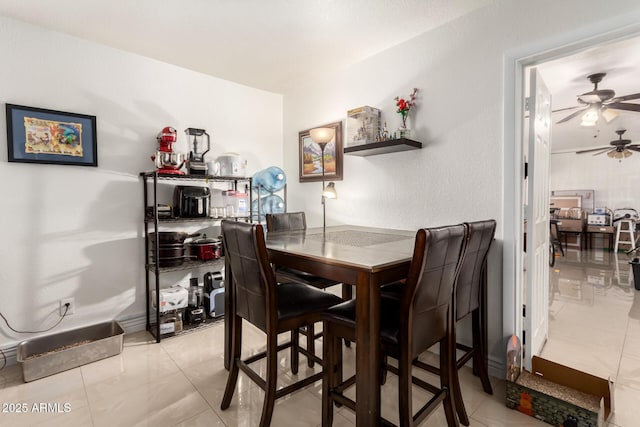 tiled dining room with ceiling fan