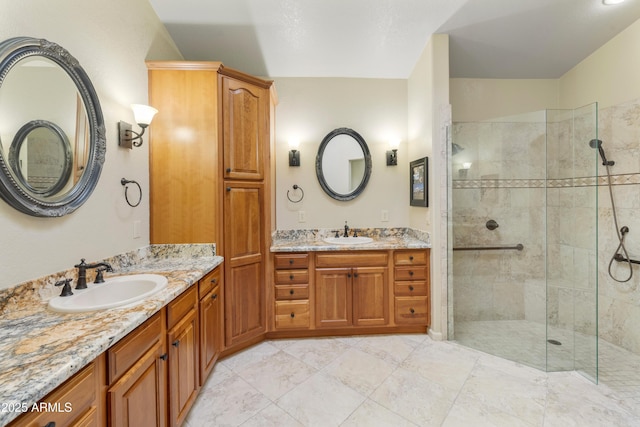 bathroom with vanity and a tile shower