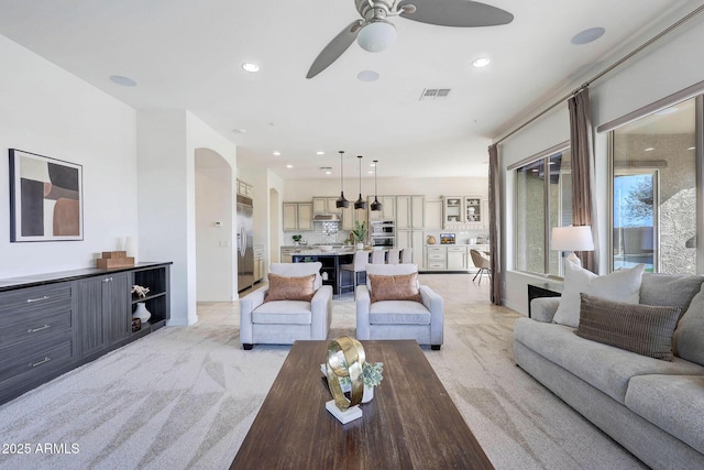 carpeted living room featuring ceiling fan