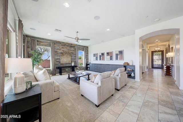 tiled living room with ceiling fan