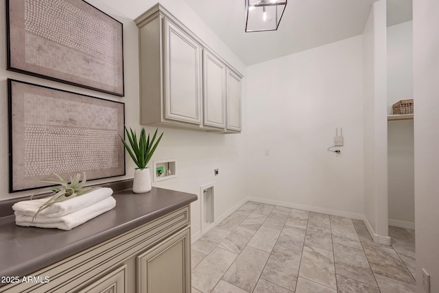 washroom featuring electric dryer hookup, washer hookup, and cabinets