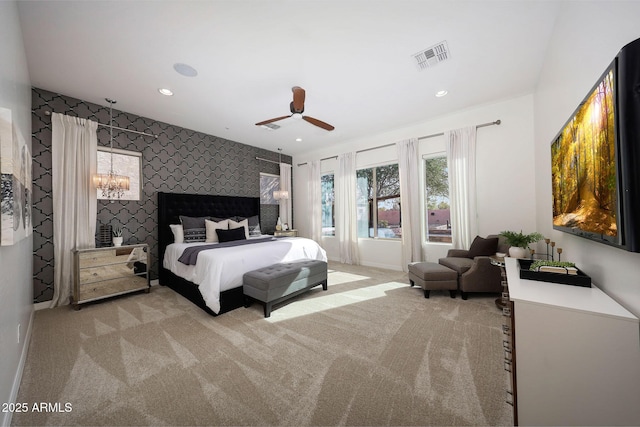 bedroom featuring light carpet and ceiling fan