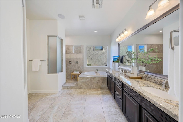 bathroom featuring vanity, tile patterned floors, and plus walk in shower