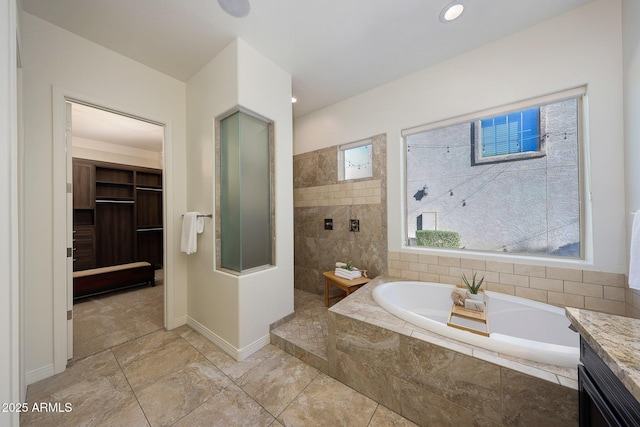 bathroom featuring vanity and separate shower and tub