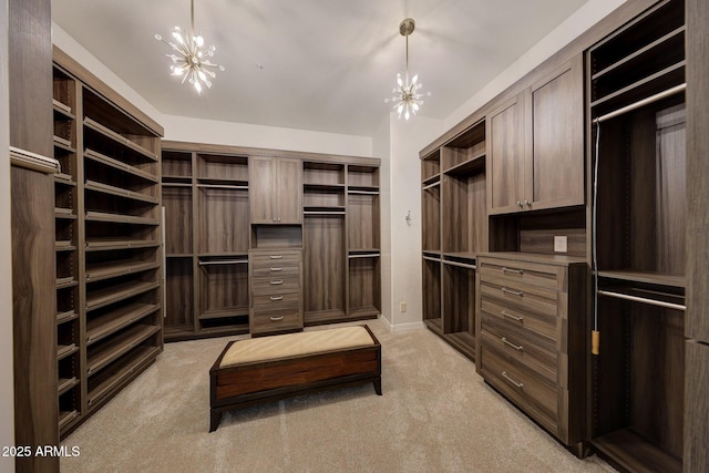 walk in closet featuring light carpet and an inviting chandelier