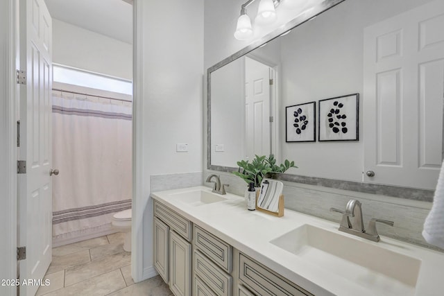 bathroom with a shower with curtain, vanity, toilet, and tile patterned flooring