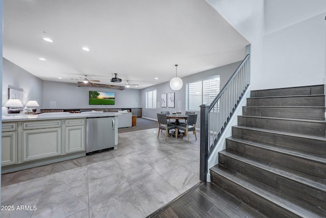 kitchen with fridge, ceiling fan, and hanging light fixtures