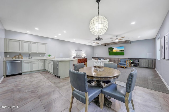 dining room with ceiling fan and sink