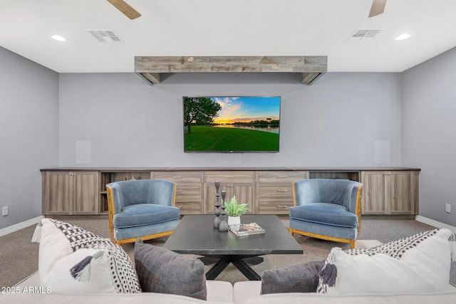 carpeted living room with ceiling fan