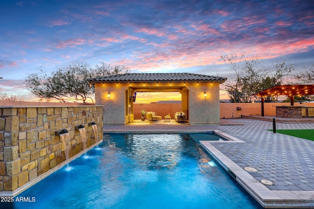 pool at dusk featuring a gazebo, pool water feature, an outdoor hangout area, and a patio area