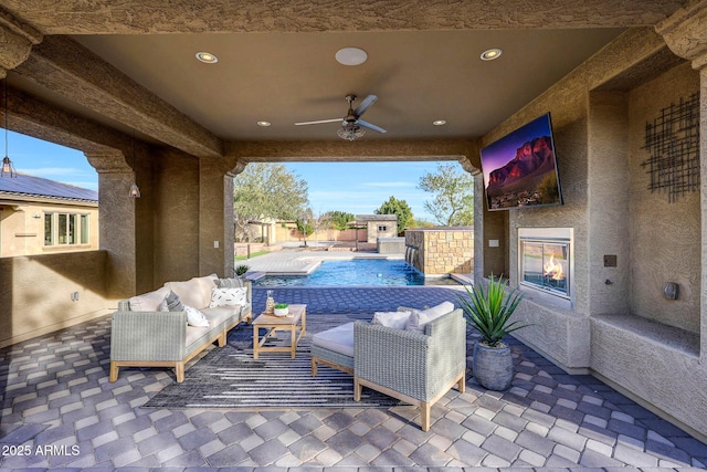 view of patio with pool water feature, ceiling fan, an outdoor hangout area, and a fenced in pool