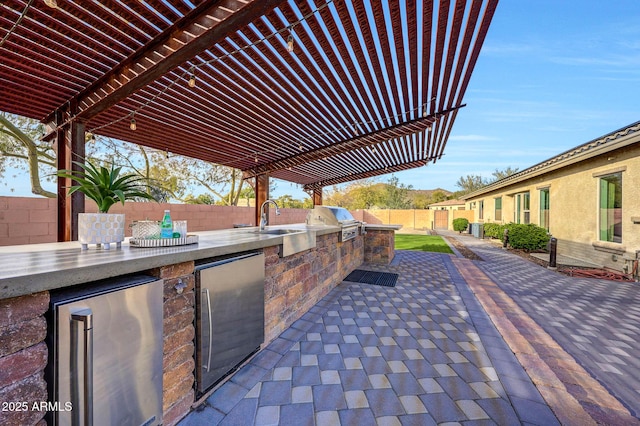 view of patio featuring area for grilling and sink