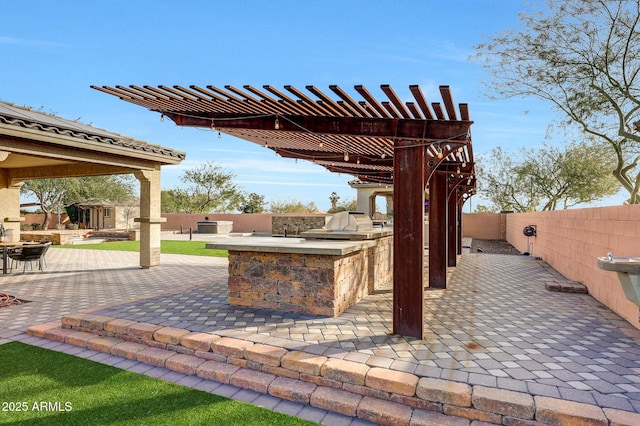 view of patio featuring an outdoor kitchen, a pergola, and an outdoor bar