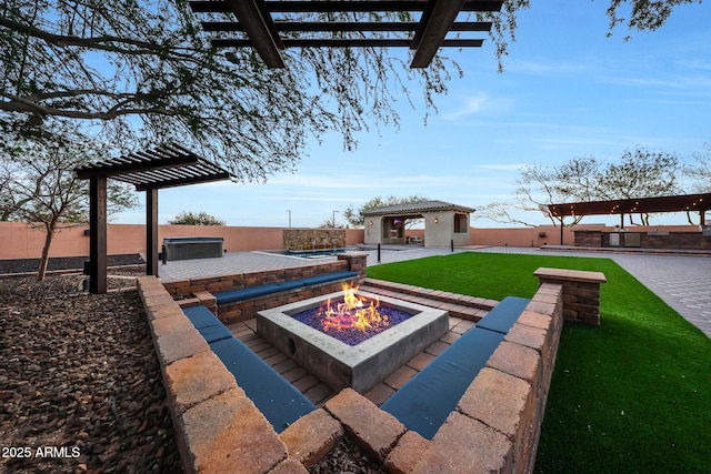 view of patio / terrace featuring a gazebo, an outdoor fire pit, a hot tub, and an outbuilding