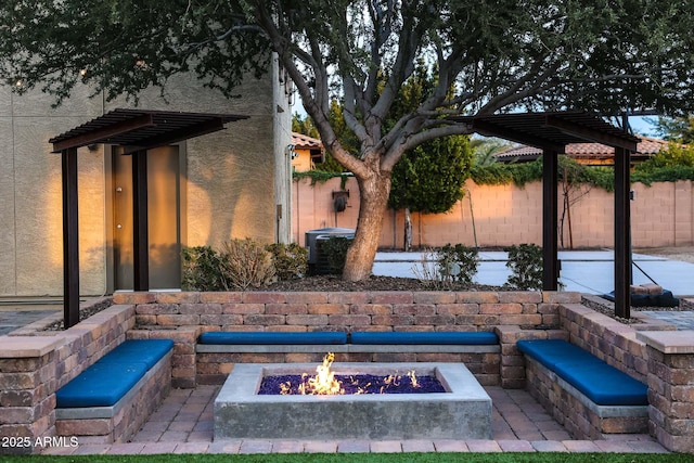 view of patio / terrace featuring central air condition unit and an outdoor fire pit