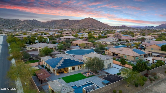 aerial view at dusk featuring a mountain view