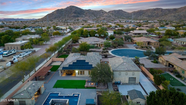 aerial view at dusk featuring a mountain view