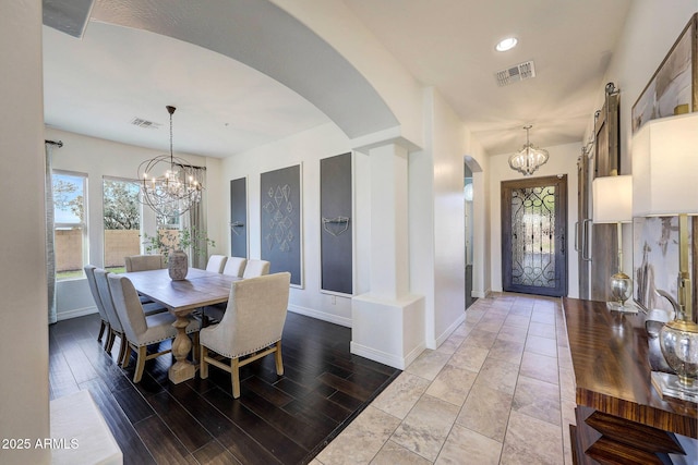 dining room with a notable chandelier and light hardwood / wood-style flooring