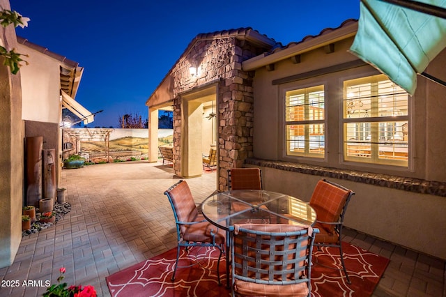 patio at night with outdoor dining area