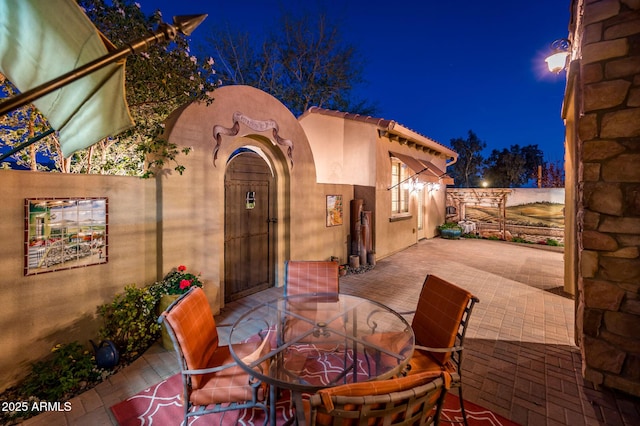 patio at twilight featuring outdoor dining space