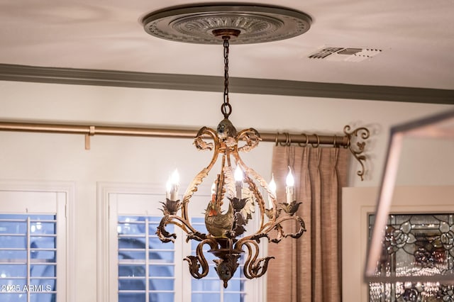 room details with visible vents, an inviting chandelier, and ornamental molding