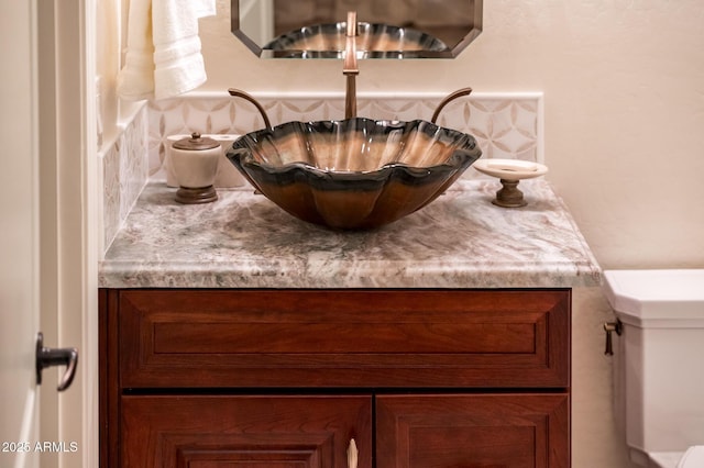 bathroom with toilet and vanity