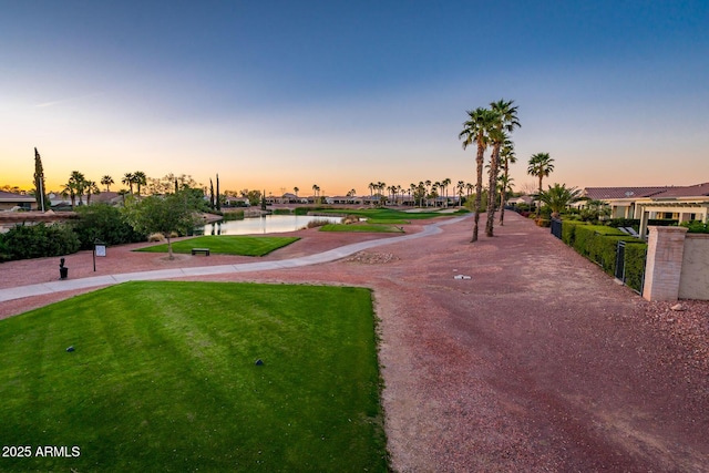 view of property's community featuring a water view and a lawn