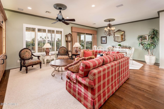 living area with recessed lighting, visible vents, wood finished floors, and crown molding